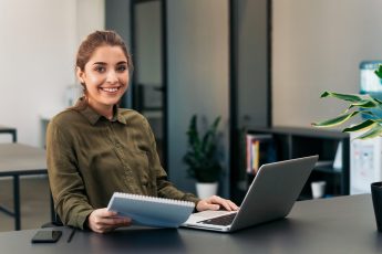 Portrait of young freelancer woman sitting at her desk.
